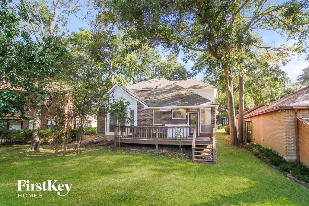 a small brick house with a porch and a deck