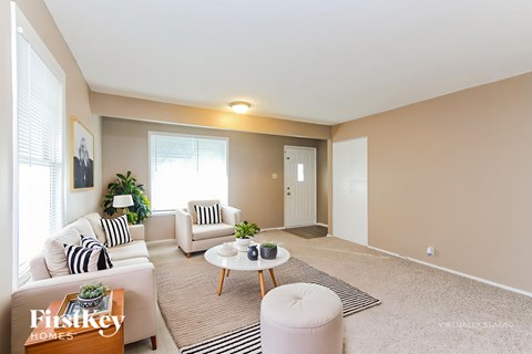 A living room with a sofa, armchair, and coffee table.