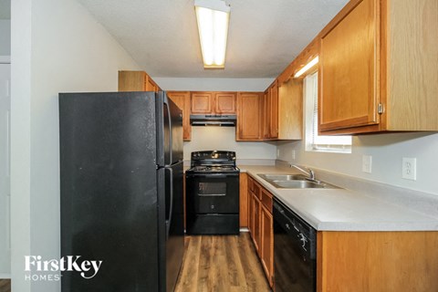 a kitchen with black appliances and wooden cabinets