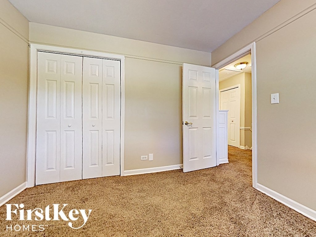 a bedroom with two closets and a door to a hallway