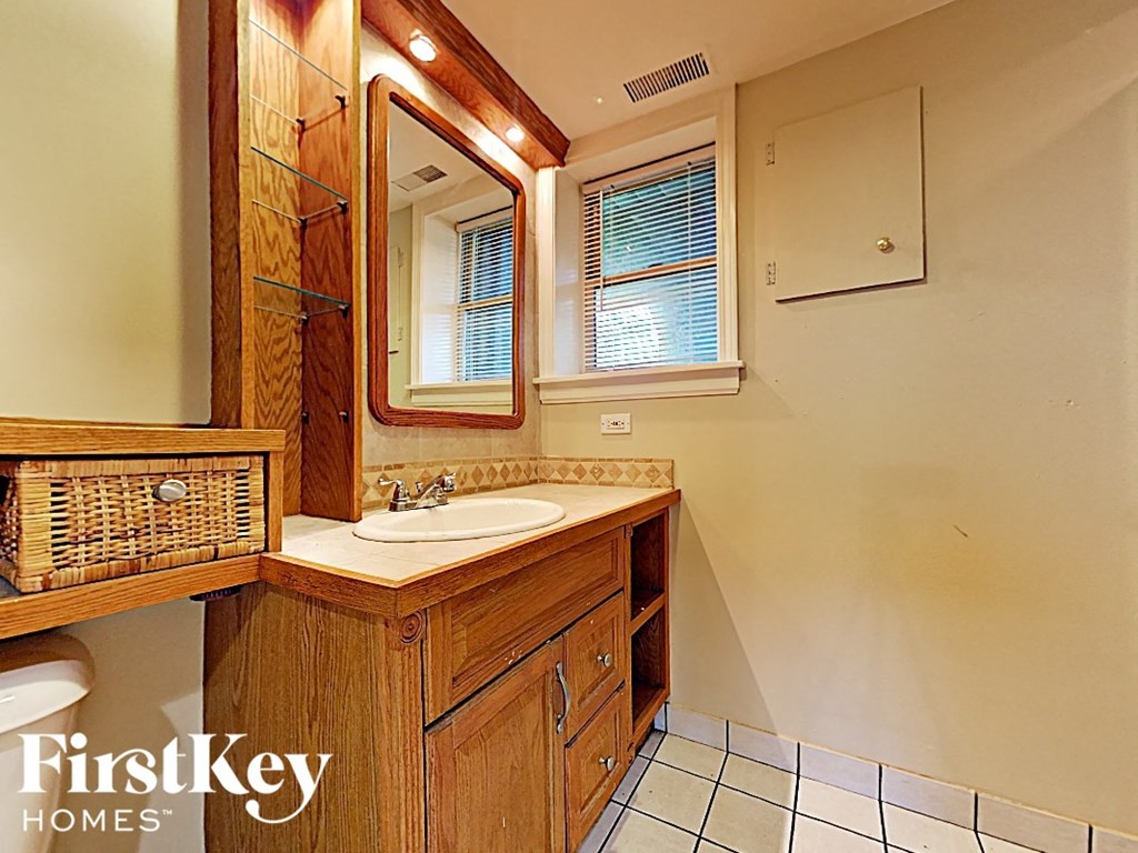 a bathroom with a sink and a mirror and a toilet