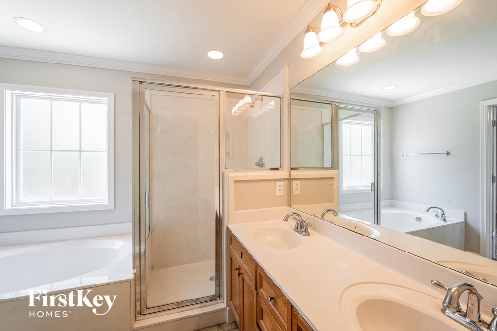 a bathroom with a sink and a shower and a tub