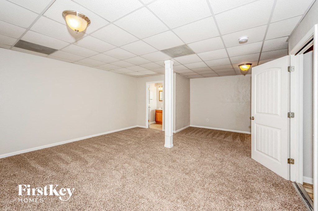 a white room with a carpeted floor and a white door