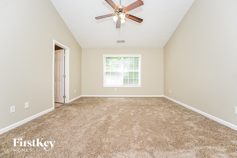 the master bedroom is spacious and has a ceiling fan