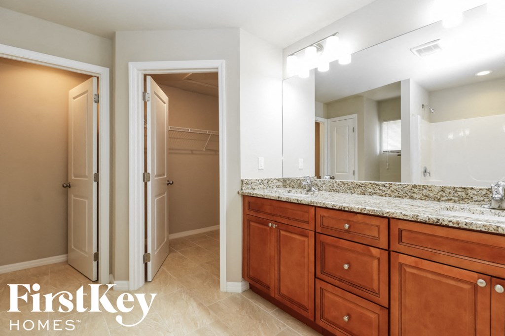 A bathroom with a vanity and a mirror.