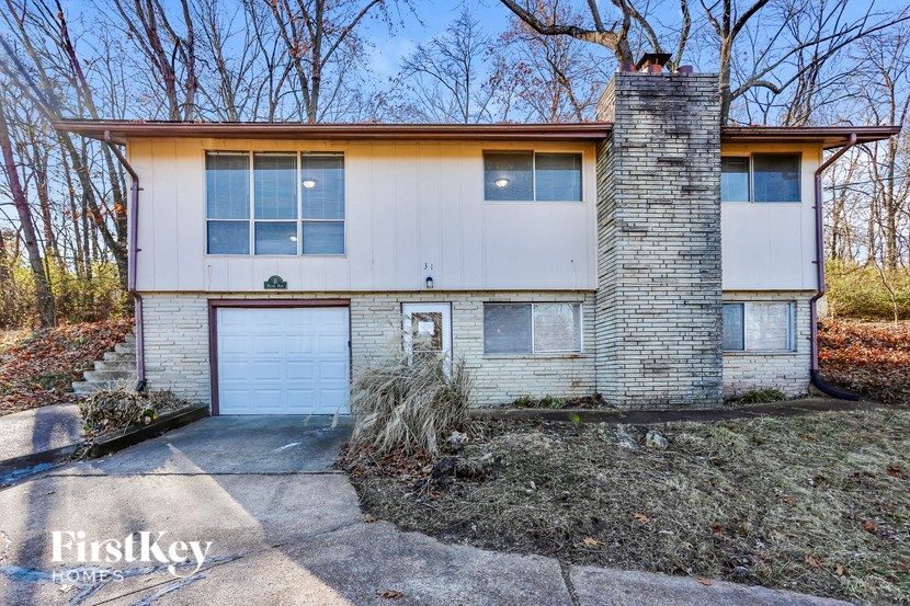 A two-story house with a garage and a chimney.