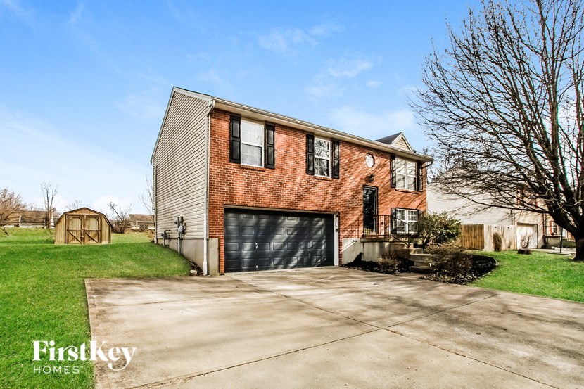 a brick house with a driveway and a garage door