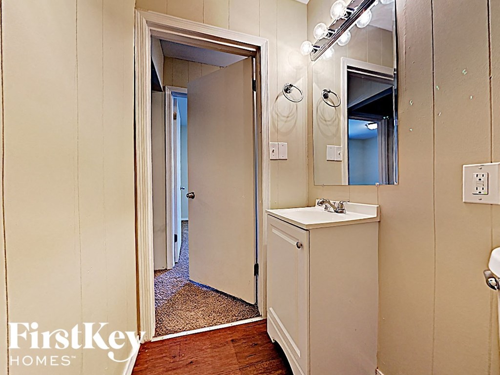 a small bathroom with a sink and a mirror
