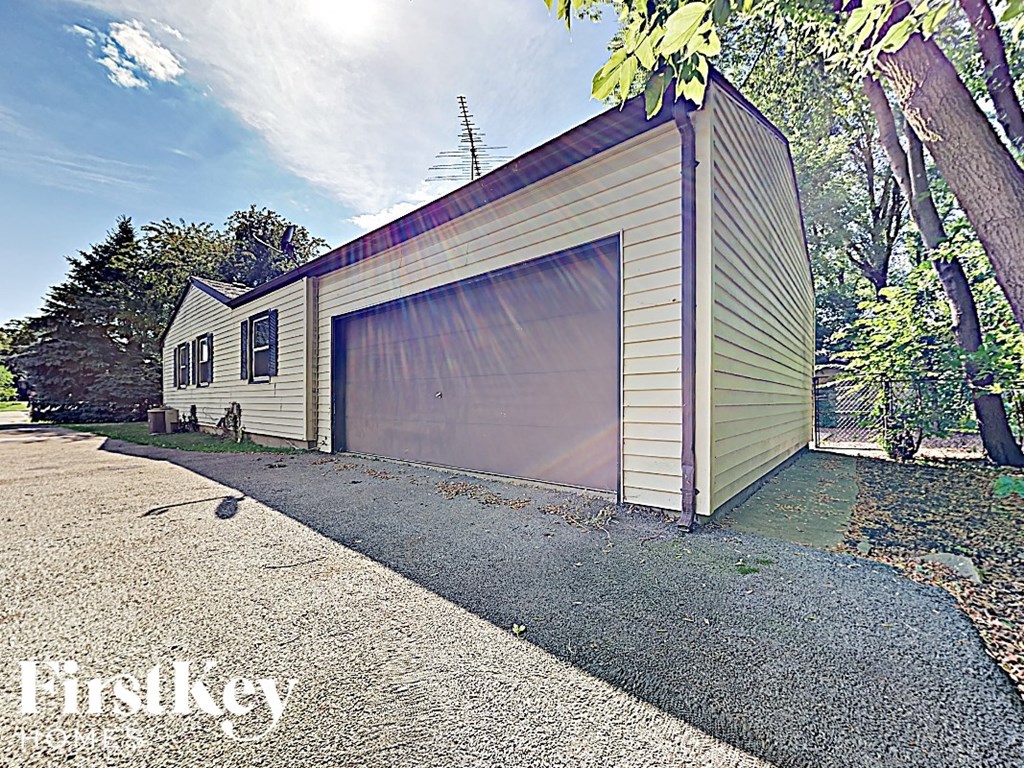 a garage with a garage door on the side of a house