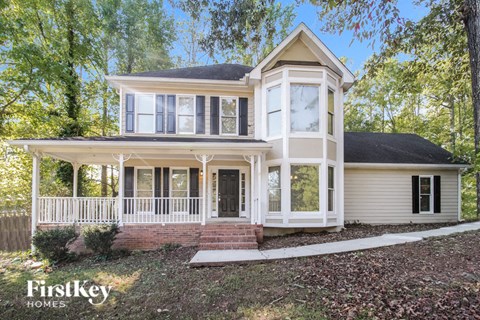 a white house with a wraparound porch
