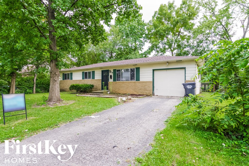 A house with a sign that says FirstKey Homes in front of it.