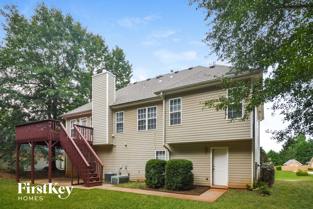 a home with a deck and a red staircase