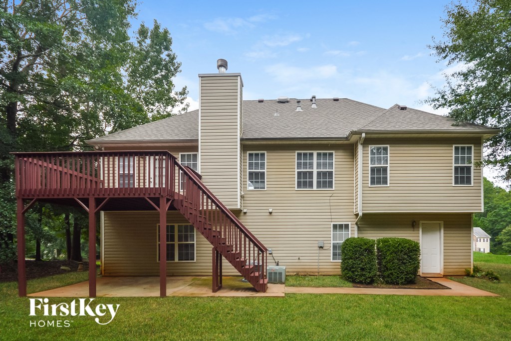 a home with a deck and a red deck railing