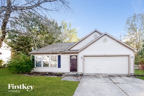 A two-car garage with a brown door is situated in front of a house.