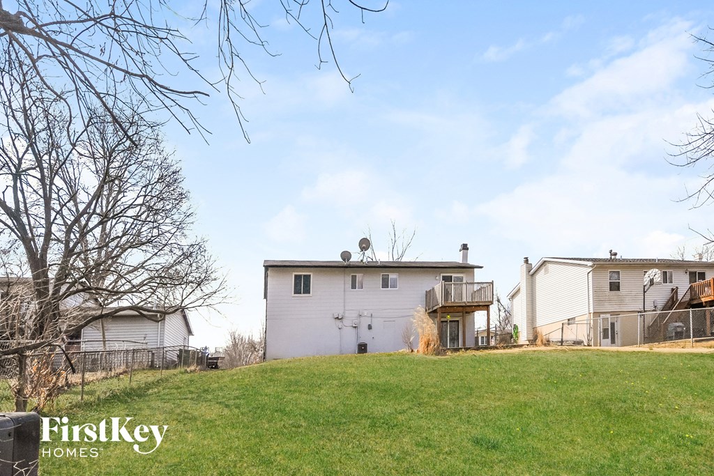 a white house on top of a grass covered hill