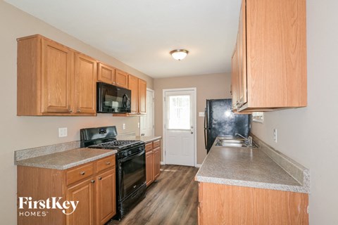 a kitchen with wooden cabinets and black appliances