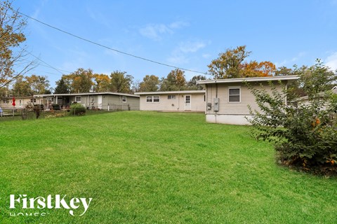a group of mobile homes in a grassy yard