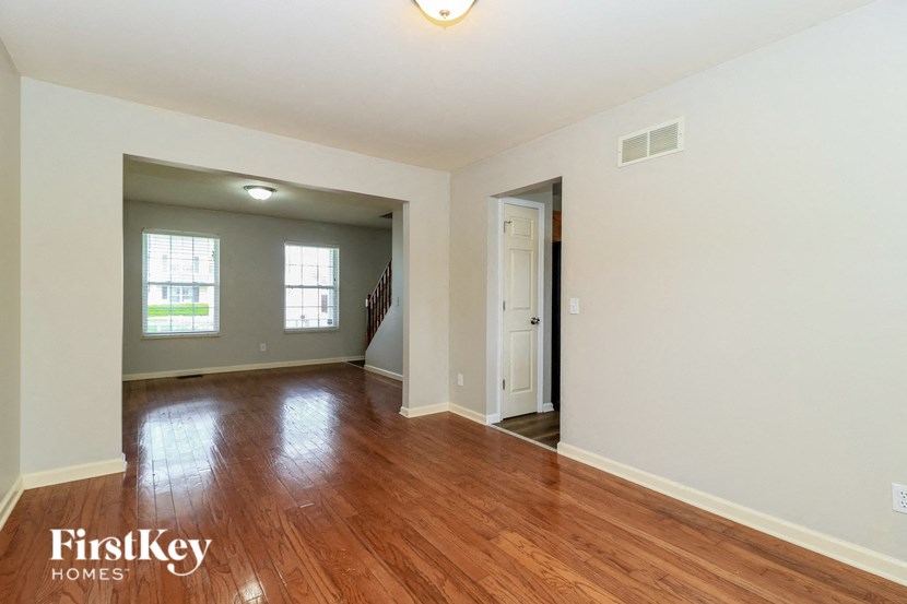 A room with wooden floors and a white door.