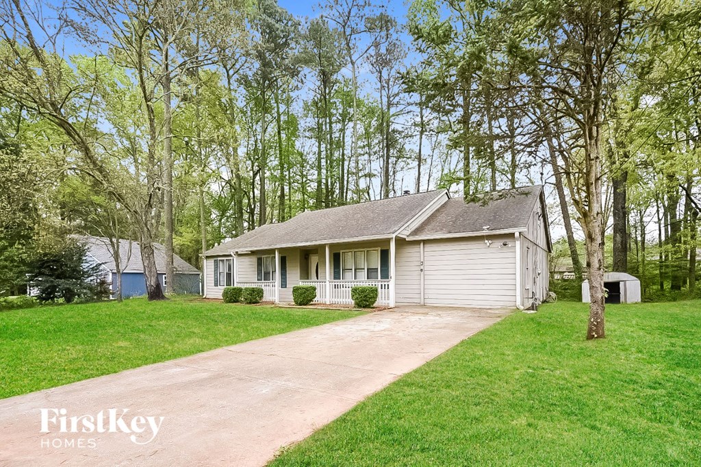 A house with a driveway in front of it.