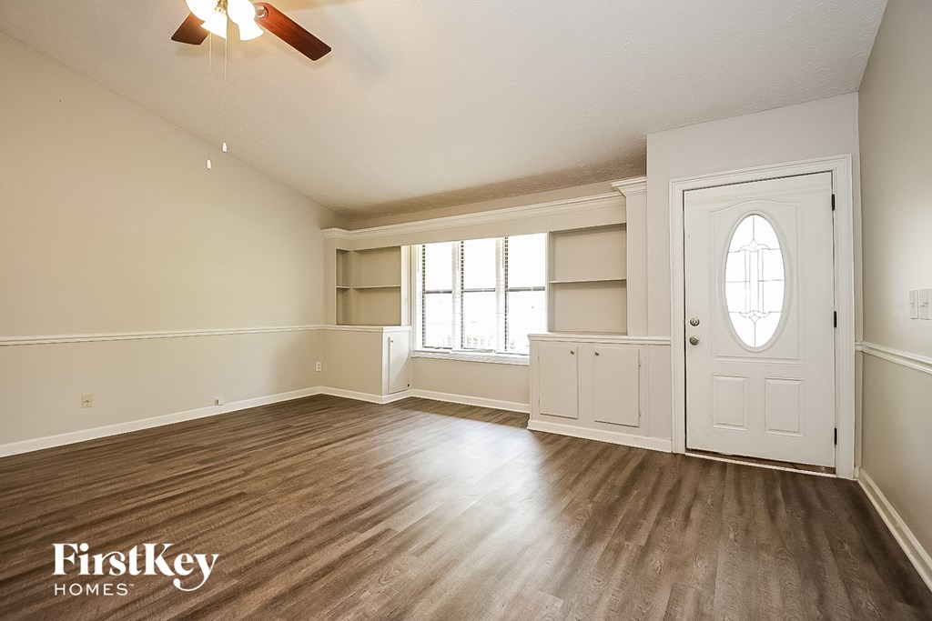 A room with wooden floors and a white door.