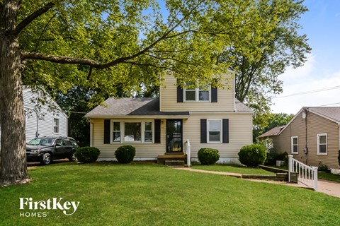 A house with a tree in front of it.