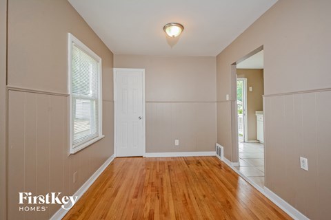 A room with wooden floors and a white door.
