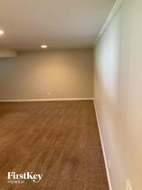 A room with wooden flooring and white walls.