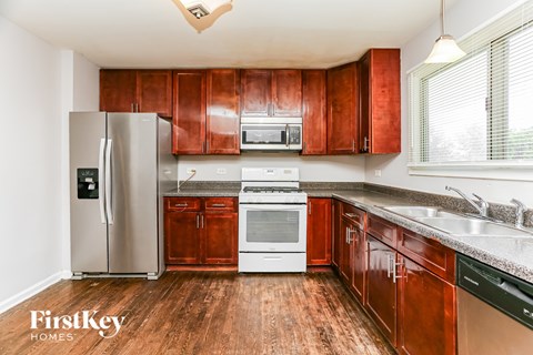 A kitchen with wooden cabinets and stainless steel appliances.
