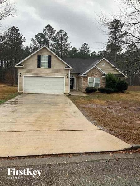a house with a driveway and a white garage door