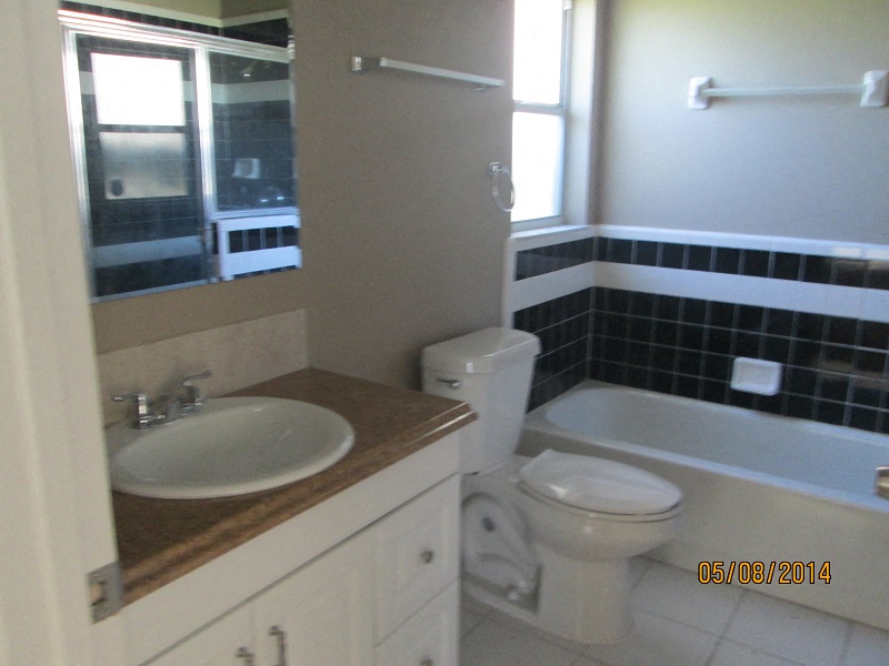a bathroom with a sink toilet and a bath tub