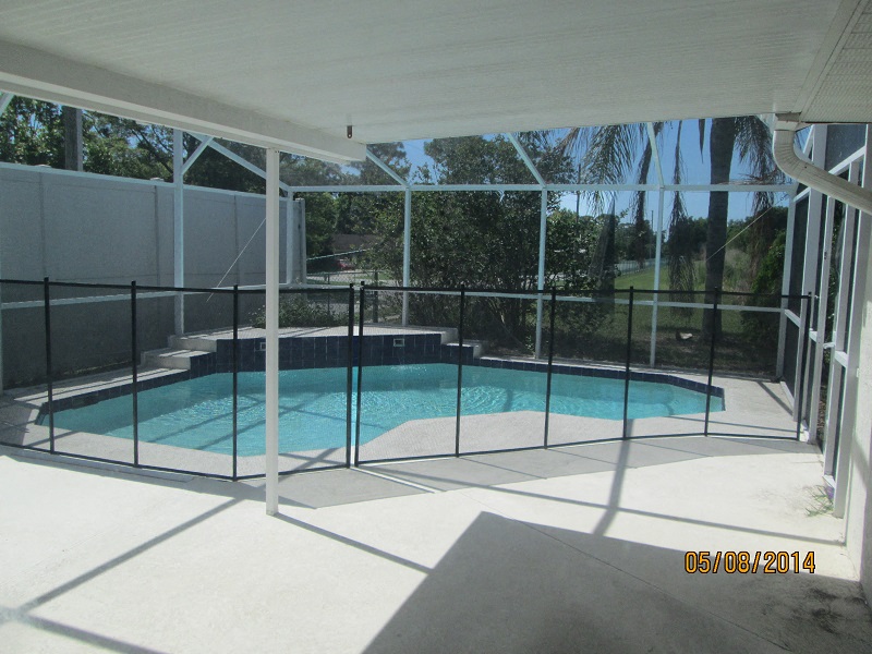 a patio with a swimming pool in a house with glass doors