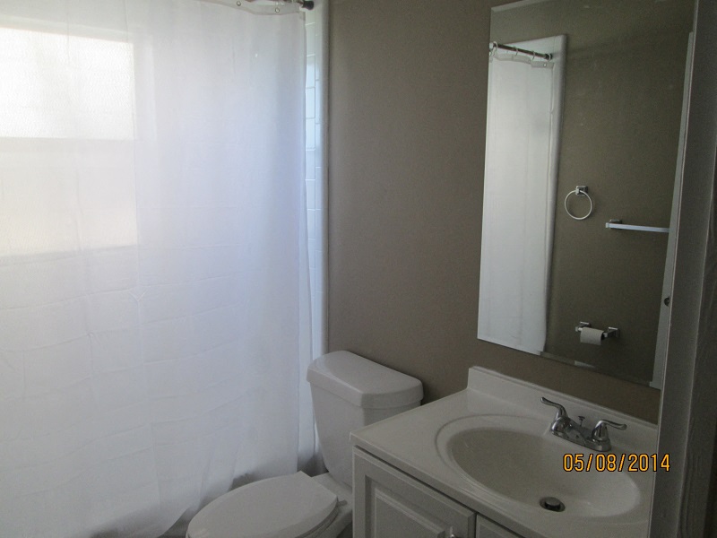 a bathroom with a sink toilet and a mirror