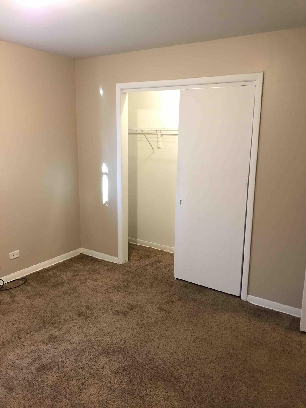 a bedroom with a closet and a door to a closet