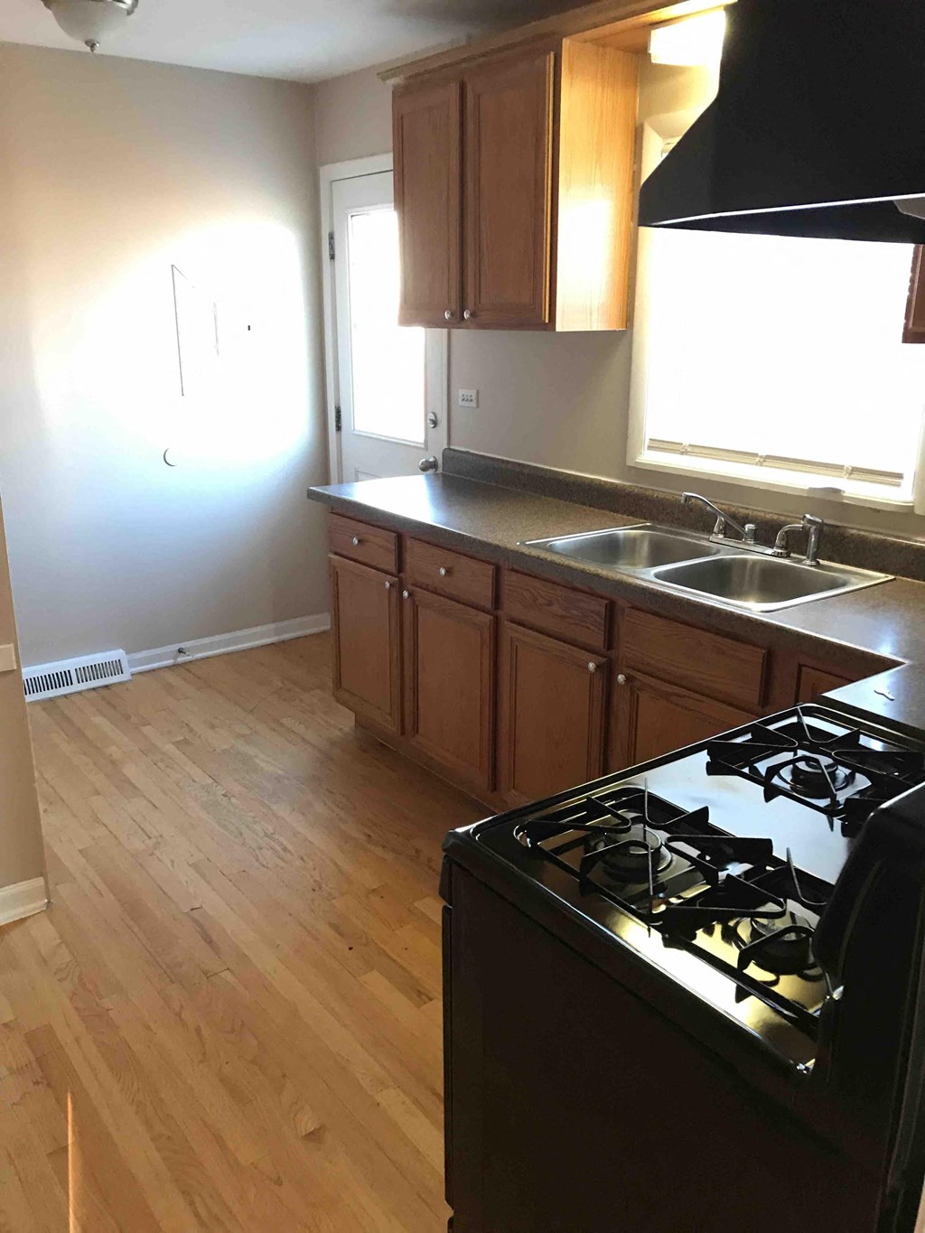 an empty kitchen with a stove and a sink