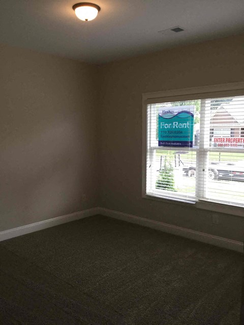 an empty room in a house with a window