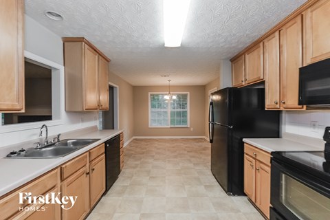 a kitchen with black appliances and wooden cabinets