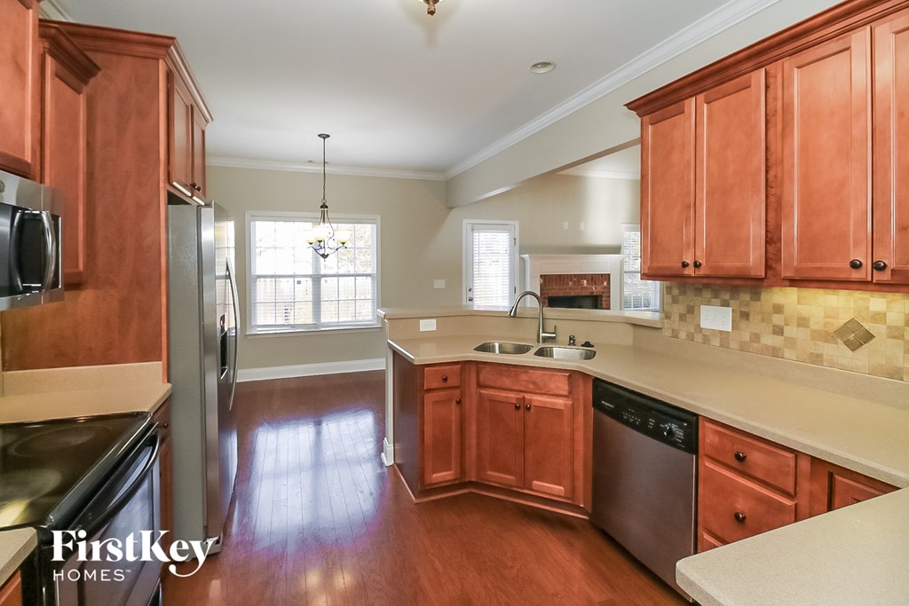 A kitchen with wooden cabinets and a refrigerator.