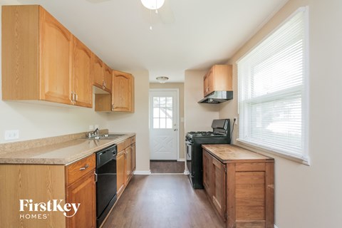 A kitchen with wooden cabinets and a countertop.