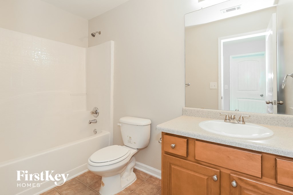 a bathroom with a toilet and a sink and a shower