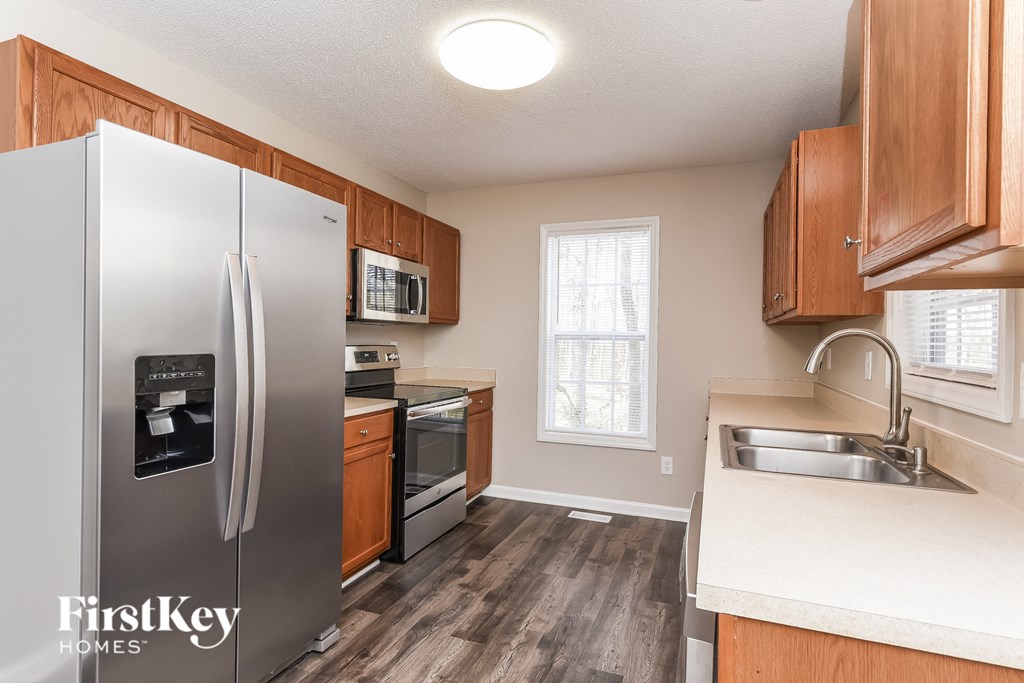 a kitchen with stainless steel appliances and wooden cabinets
