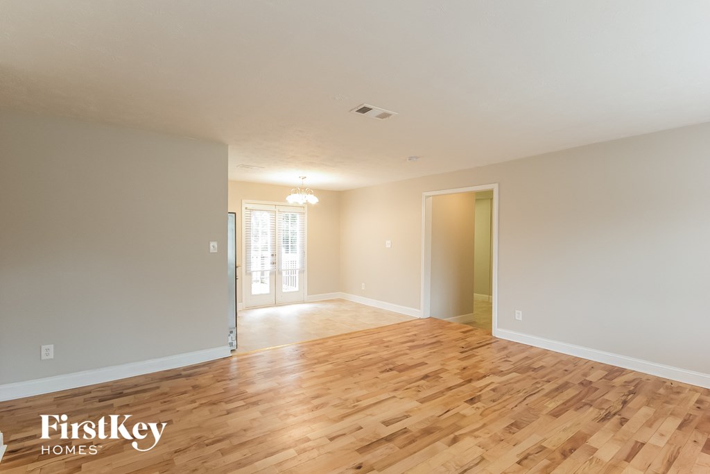 the living room and dining room with wood flooring