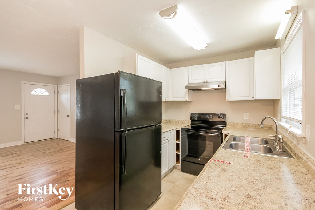 a kitchen with stainless steel appliances and white cabinets