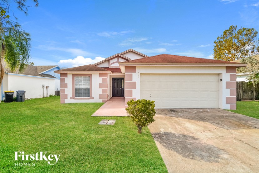 A house with a brown roof and a white garage door is for sale.