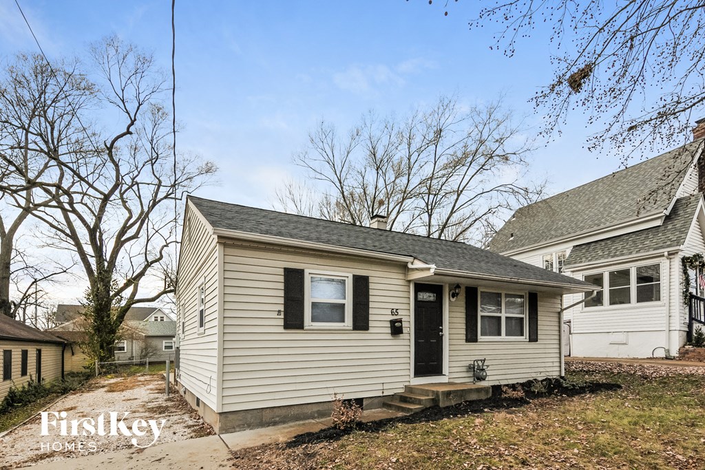 the front of a small house with a black door