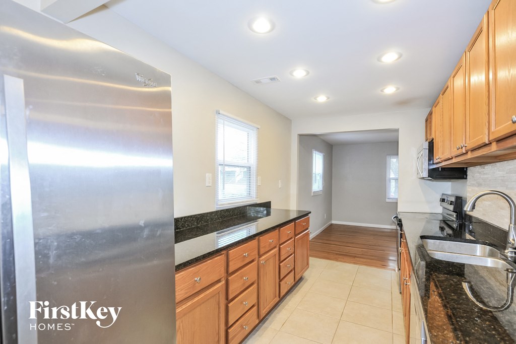 a kitchen with granite counter tops and wooden cabinets and a sink