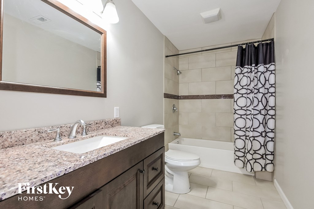 a bathroom with a sink and a toilet and a shower