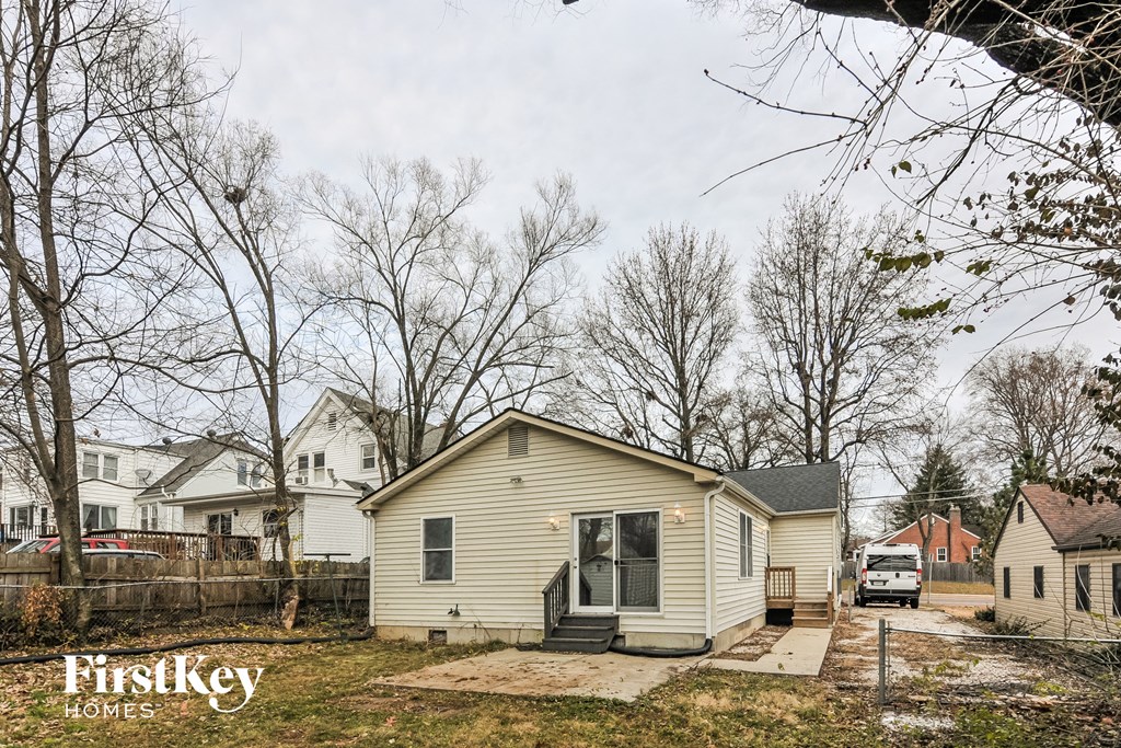a small house with a driveway and a van parked in front of it