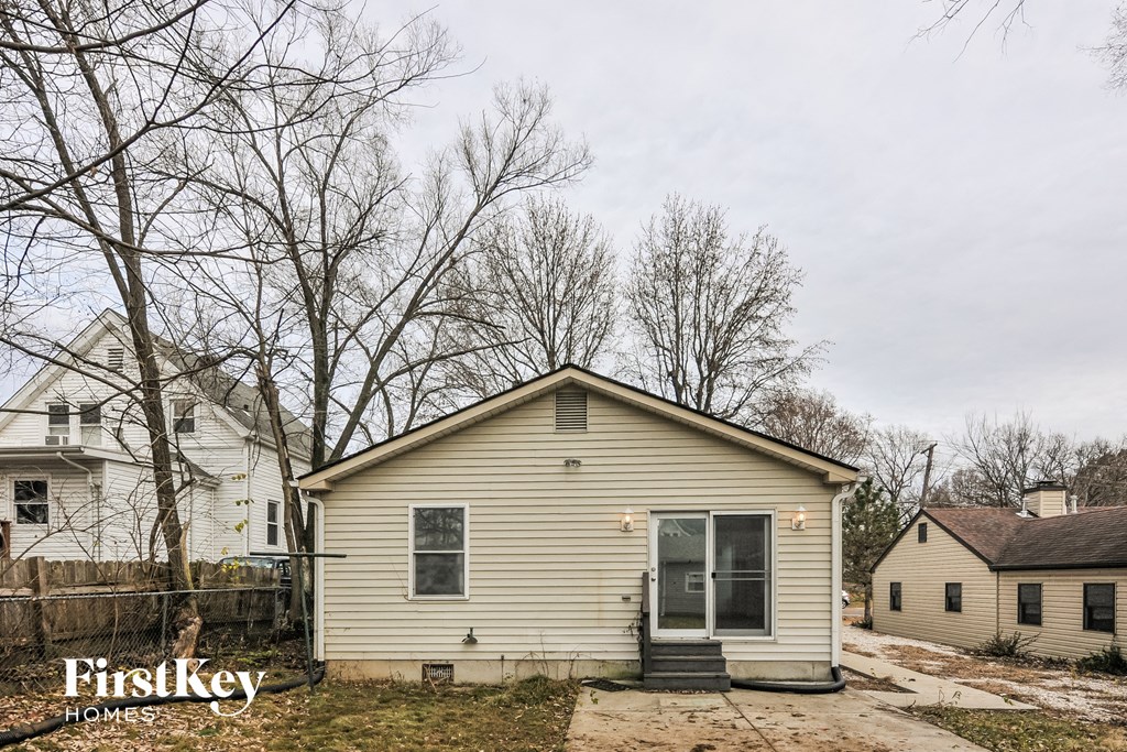 the front of a house with a yard and trees