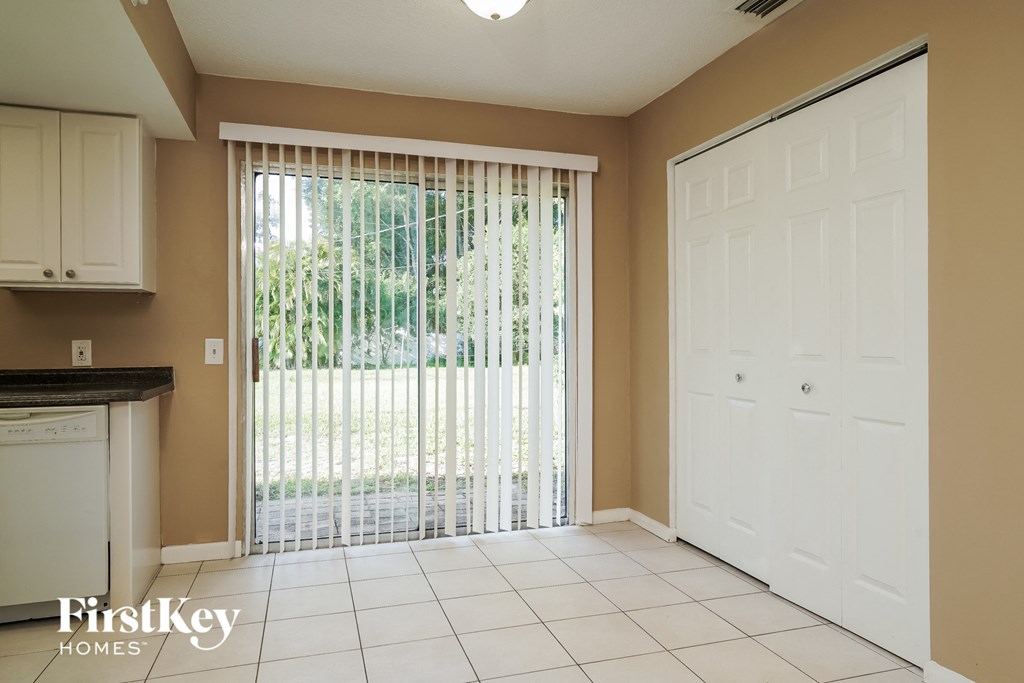 A kitchen area with a dishwasher and a FirstKey Homes logo.