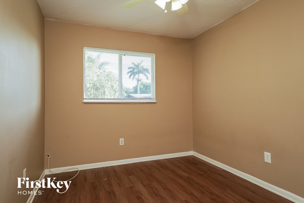 A room with a window and wooden floors.